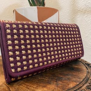 Purple and gold clutch bag